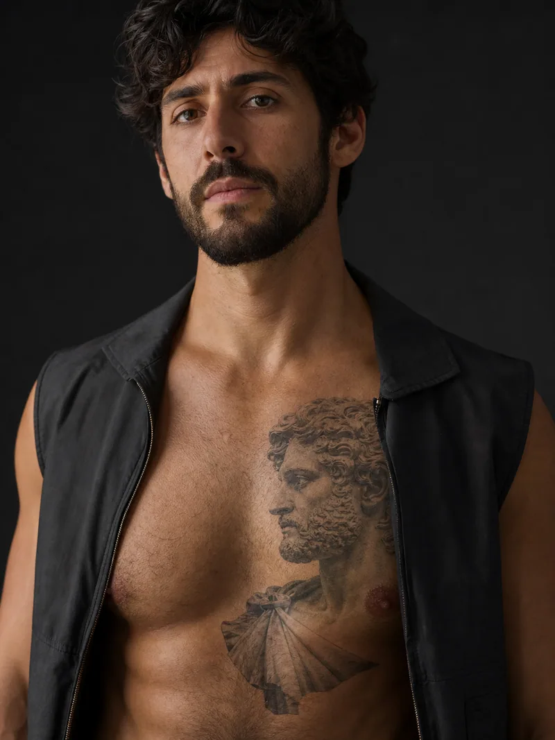 Roman statue chest tattoo - A classical statue fragment reads like an etched museum study.