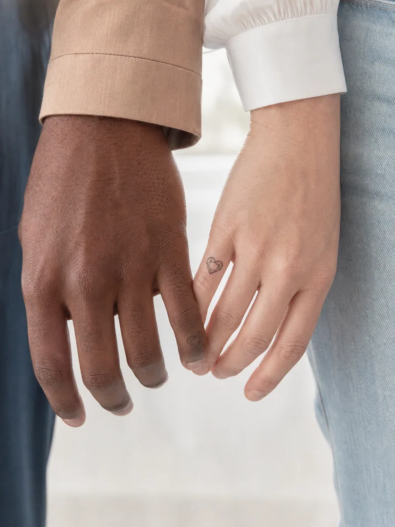 Tiny heart finger tattoos - small geometric hearts that meet when two hands touch