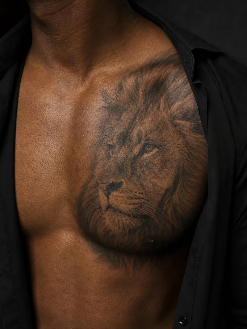 Realistic lion chest tattoo - lion portrait following the shape of a man's chest