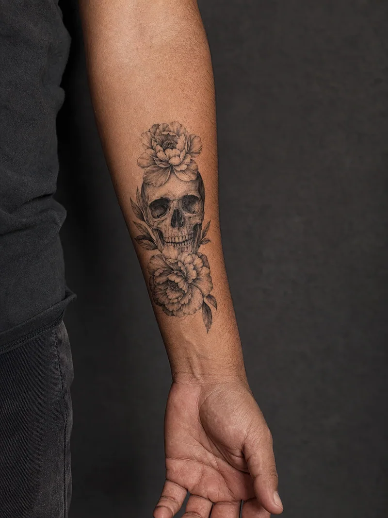 Skull and flowers - A contrast piece pairing a hard subject with soft botanical framing.