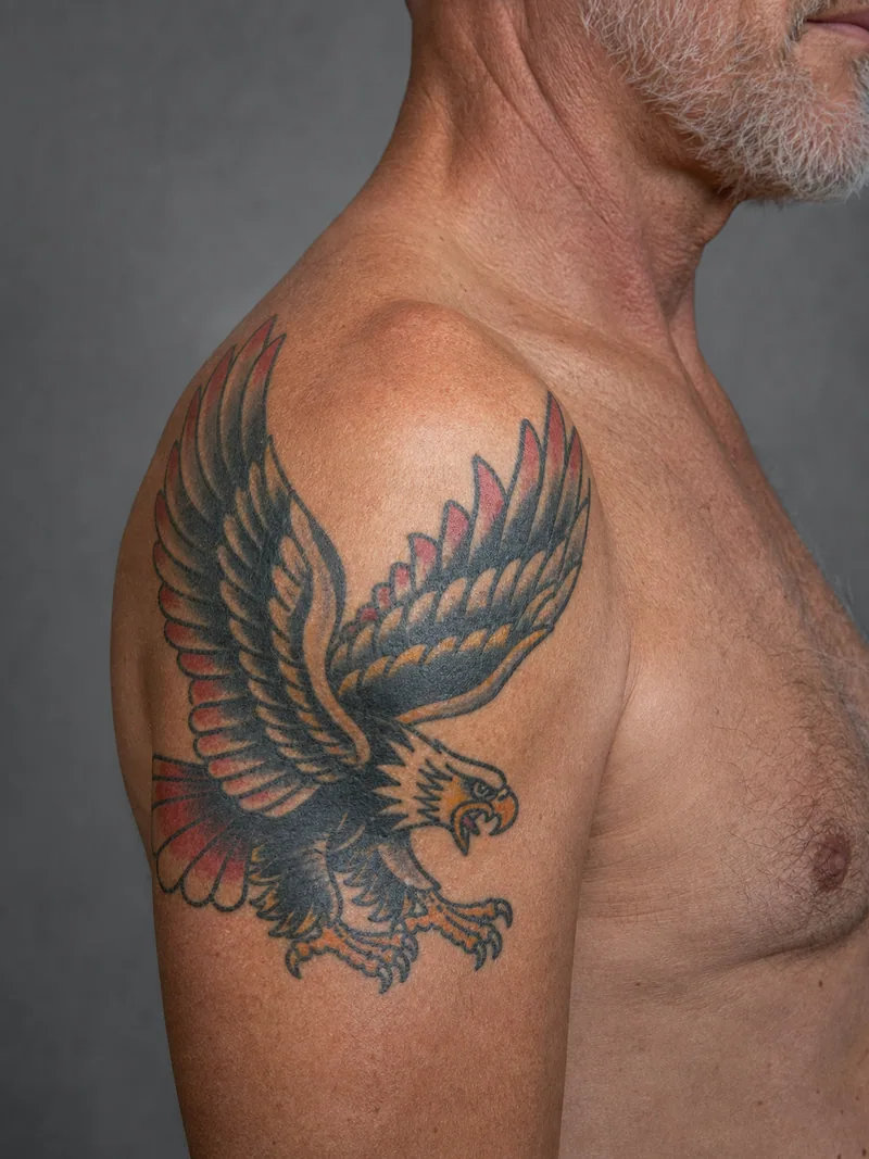 Eagle shoulder tattoo - classic eagle with spread wings fitted to the round shape of the shoulder