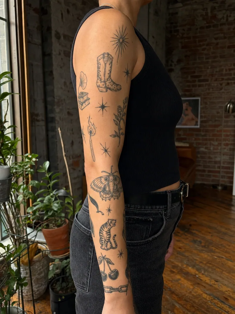 Patchwork sleeve tattoo - cowboy boot, dice, moth, match, tiger, starburst and cherries with open spacing