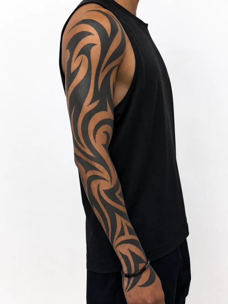Modern neo-tribal sleeve tattoo - bold contemporary curves and hooks forming a clean high-contrast arm pattern