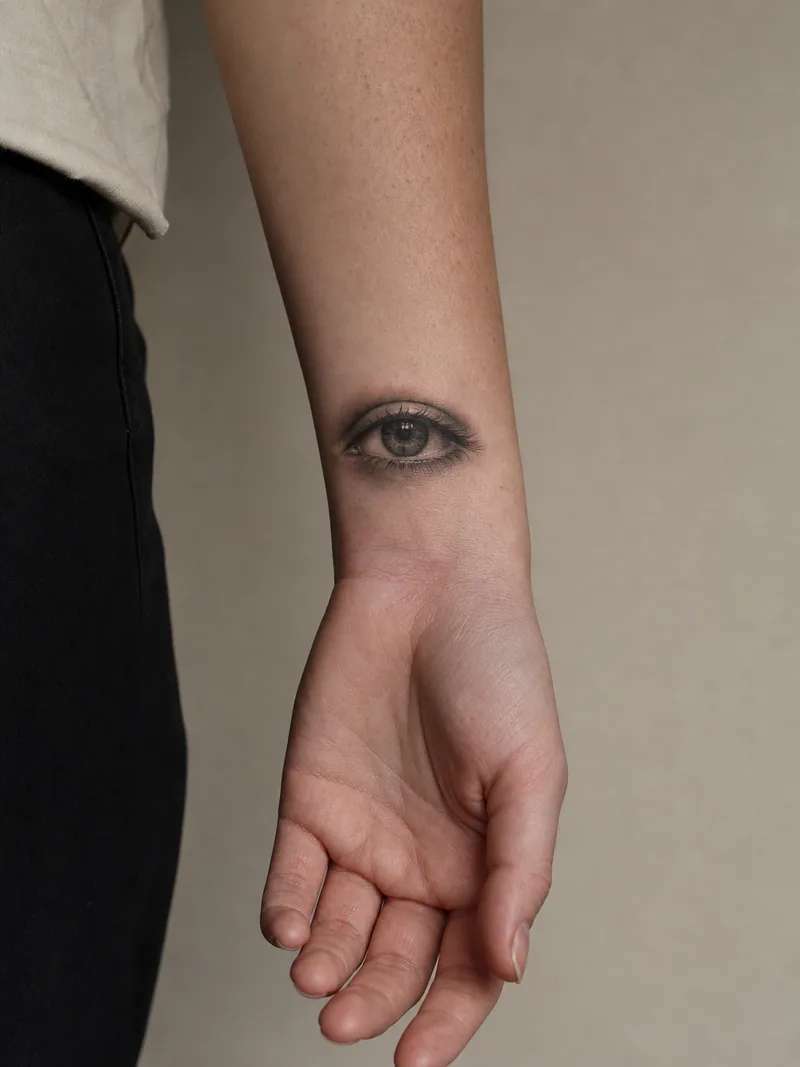 Realistic eye wrist tattoo - high-detail eye placed above the wrist crease with soft natural shading
