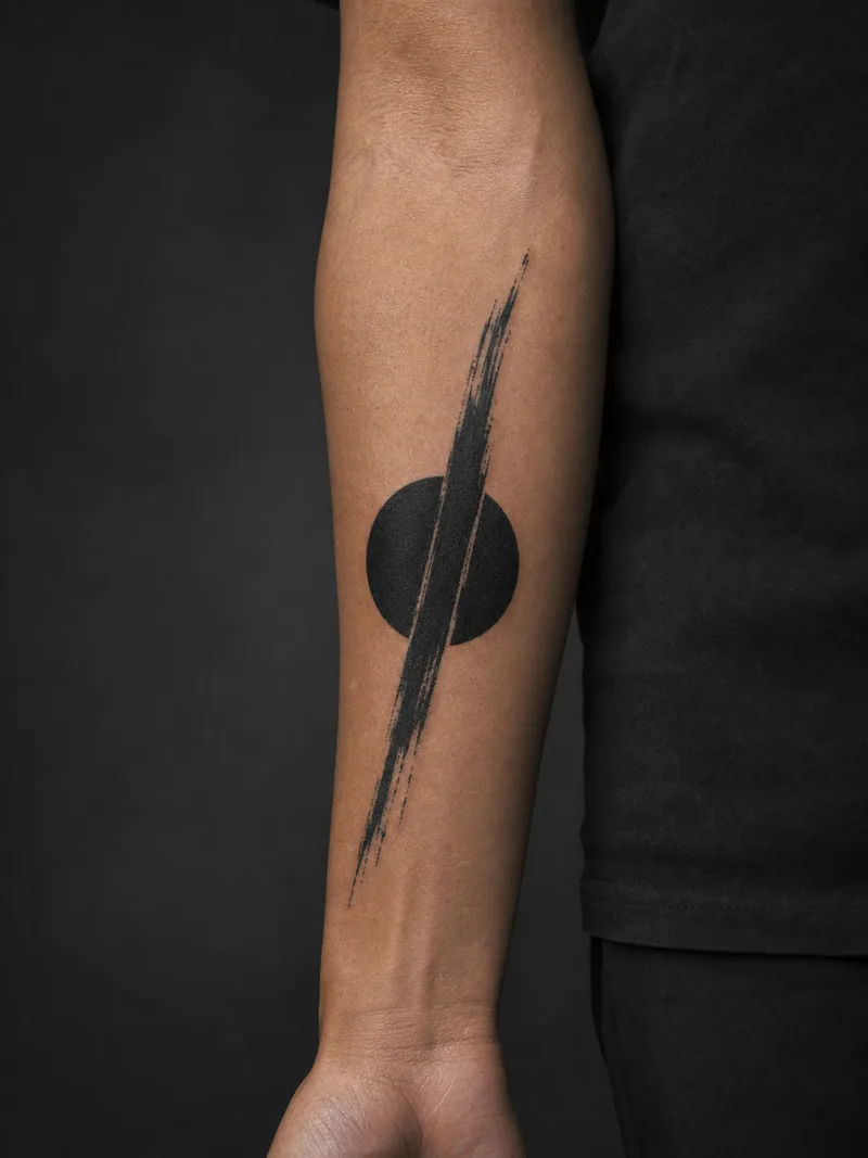 Abstract blackwork tattoo - a dry-brush slash crossing one perfect solid circle