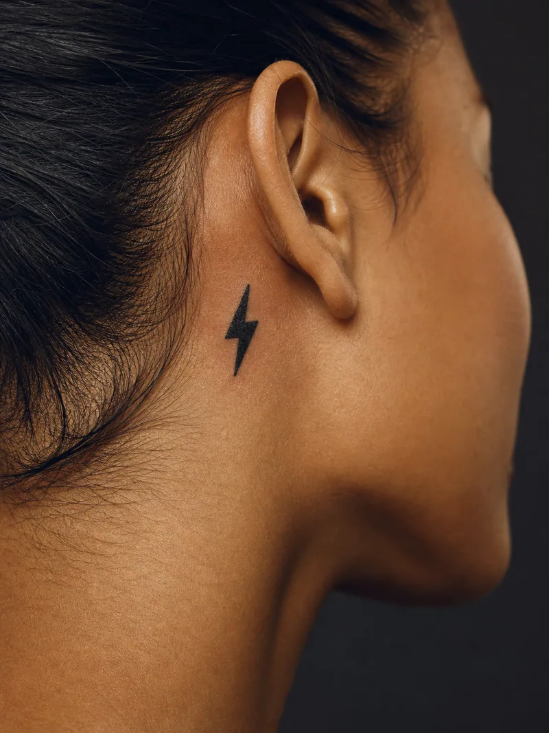 Lightning bolt tattoo - one precise solid lightning bolt with clean edges and open skin around it