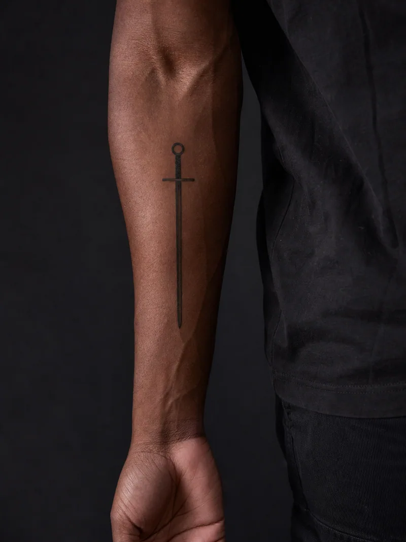 Minimal sword tattoo - a straight sword reduced to a narrow blade and simple circle pommel