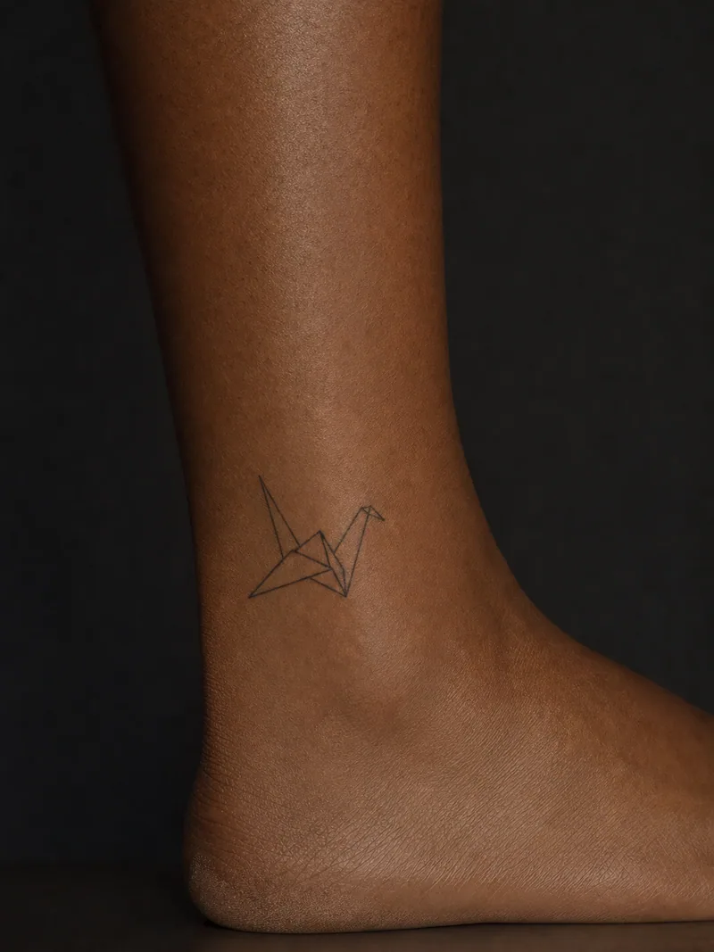 Origami crane tattoo - an origami crane described by six precise angular lines