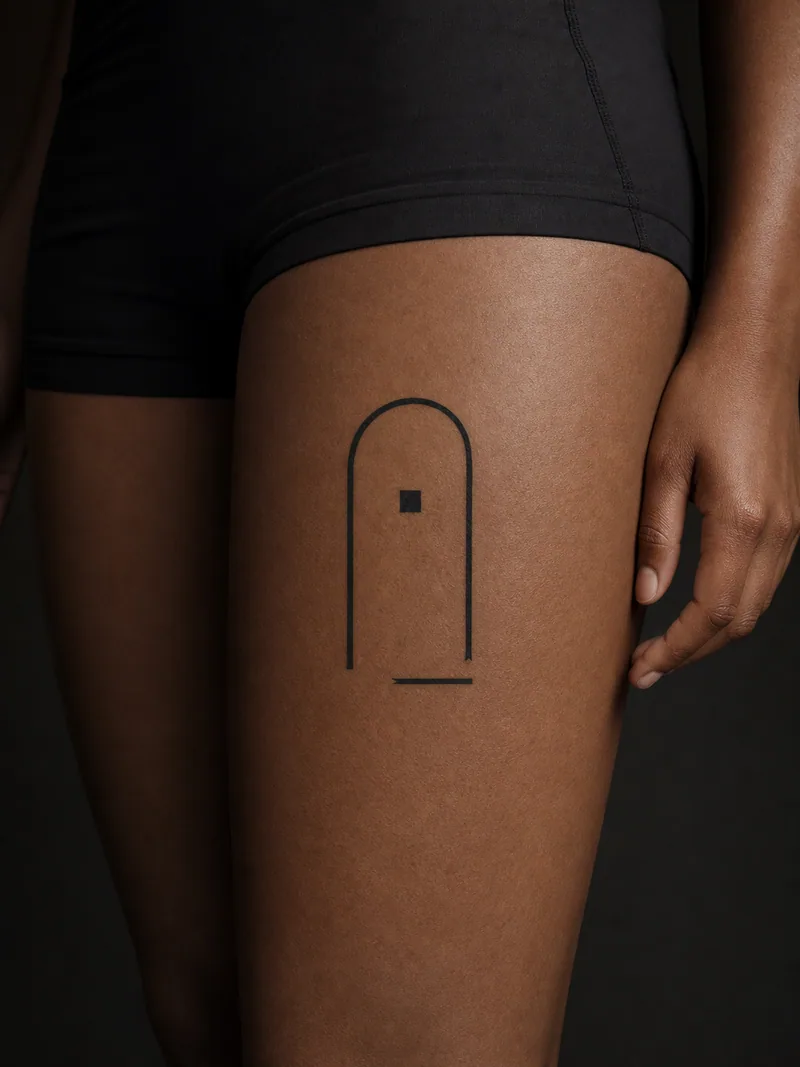 Abstract doorway tattoo - a tall arch balanced by one floating square and a short baseline