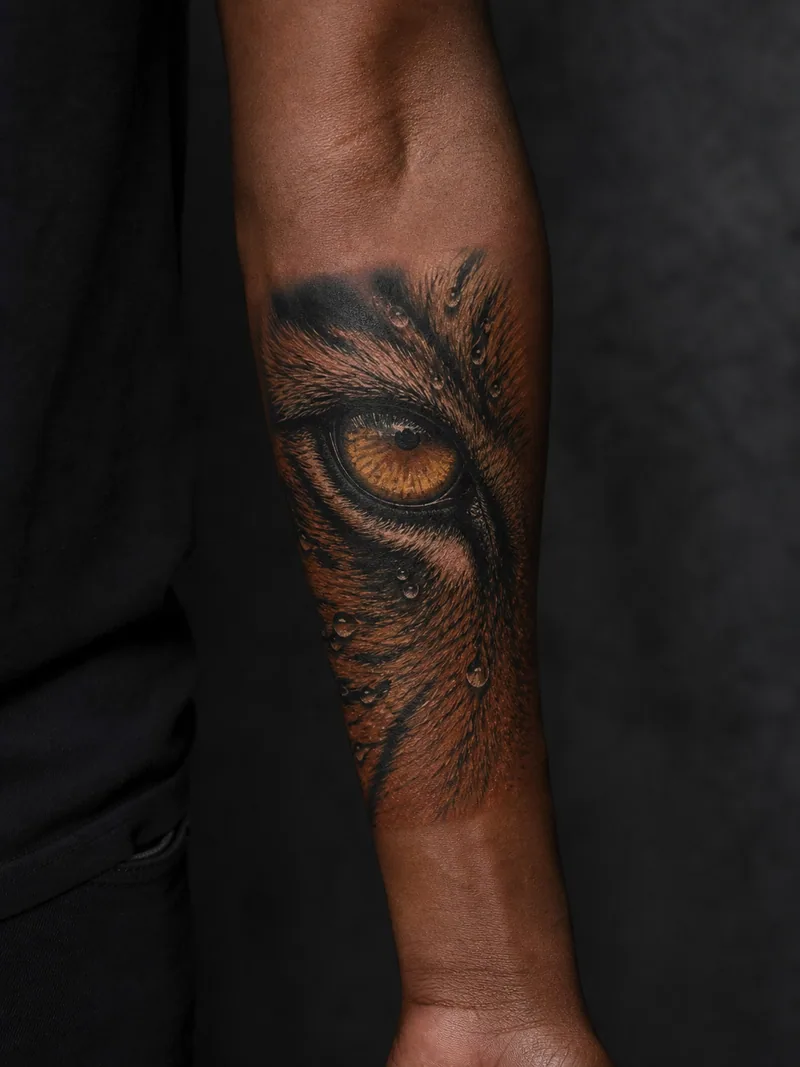 Tiger eye tattoo - an amber tiger eye framed by wet orange fur