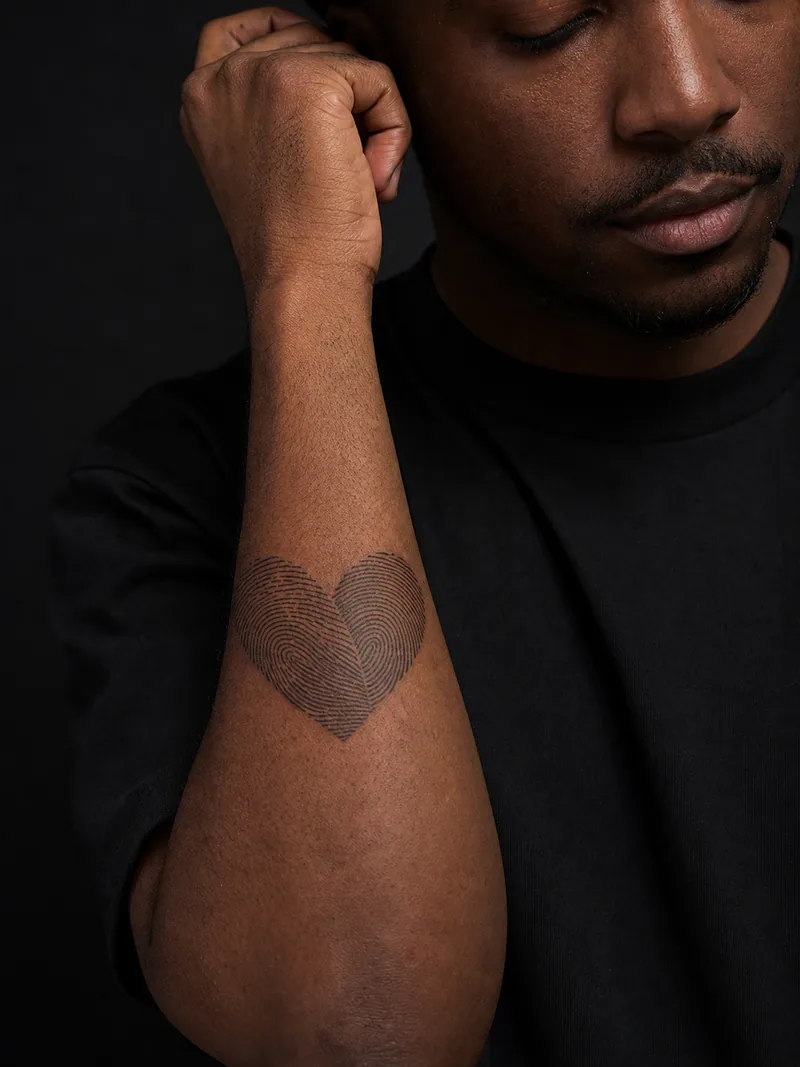 Fingerprint heart tattoo - heart shape formed from two precise interlocking fingerprint patterns