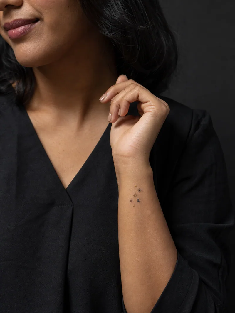 Tiny stars wrist tattoo - small cluster of five stars and one miniature crescent