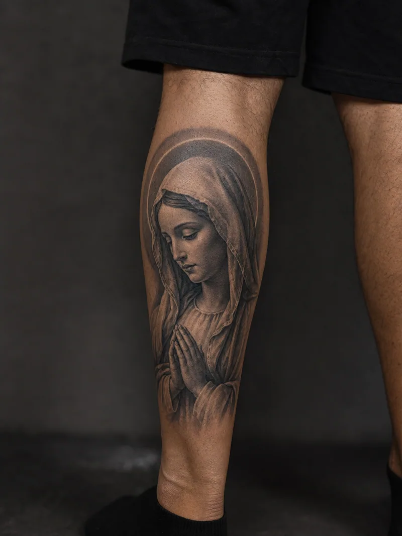 Virgin Mary tattoo - respectful portrait with a folded veil, halo and praying hands