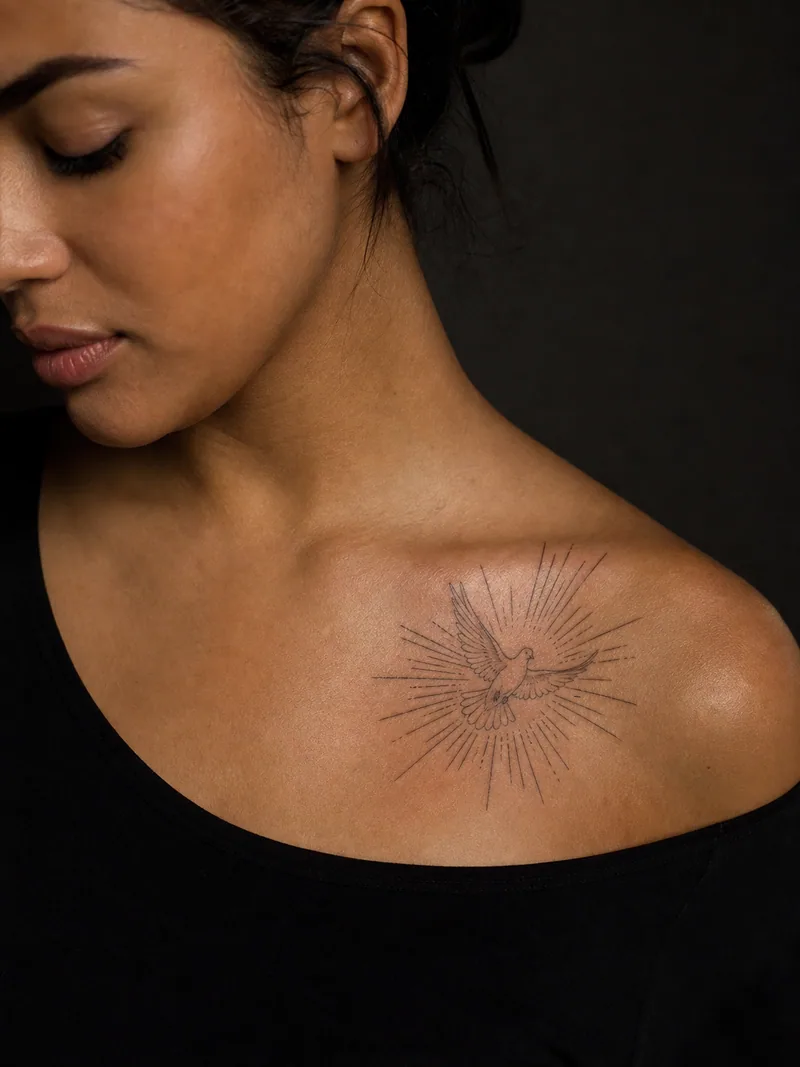 Dove collarbone tattoo - dove in flight centred inside clean radiating lines