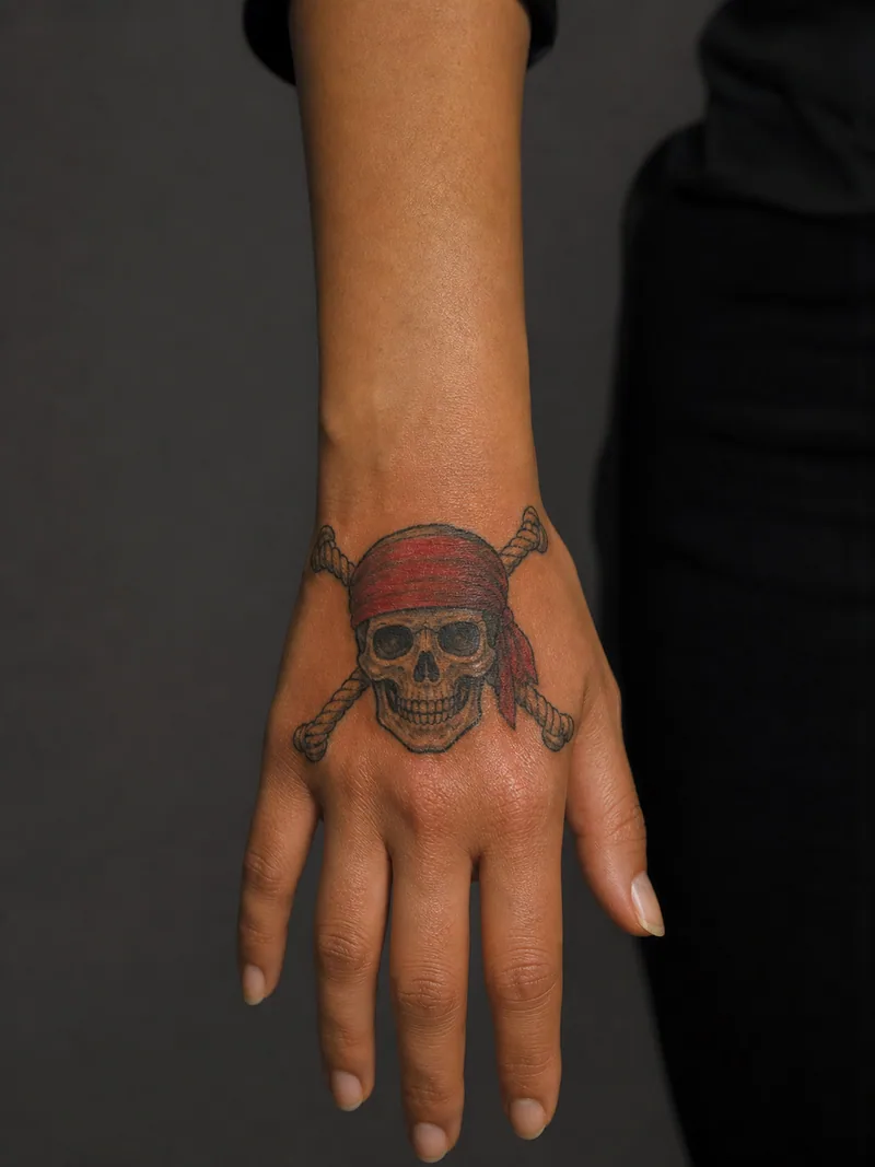 Pirate skull hand tattoo - pirate skull with a bandana and crossed nautical ropes