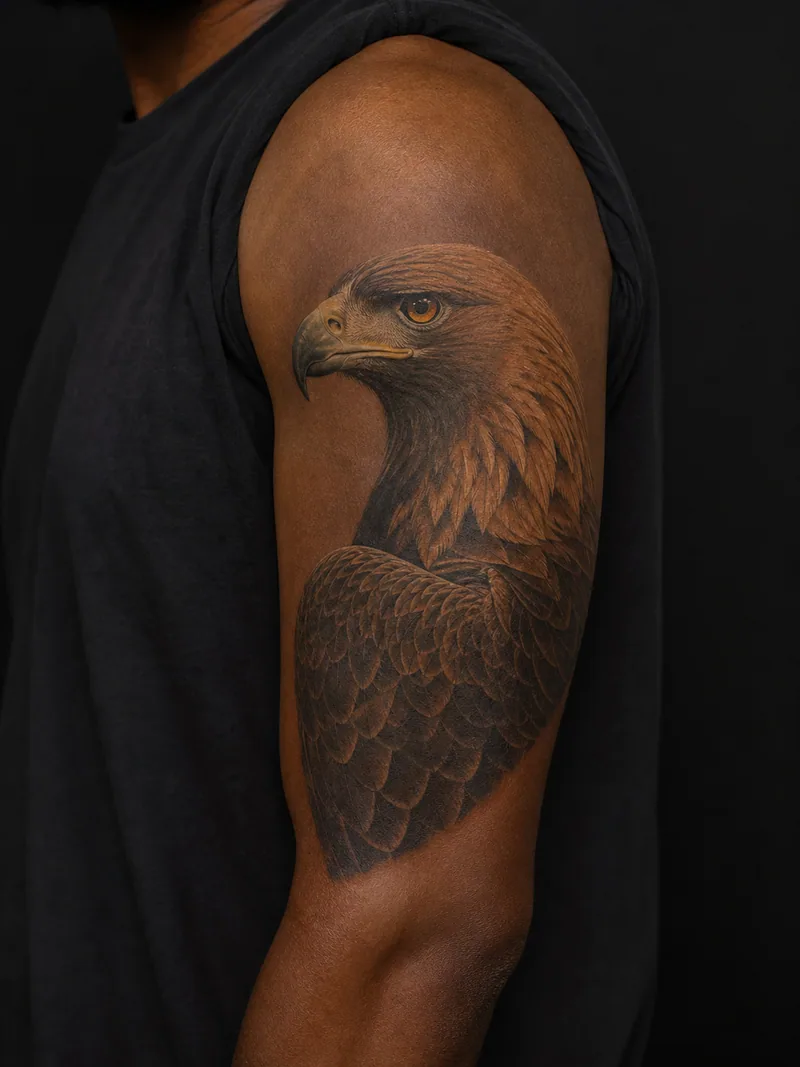 Golden eagle tattoo - A realistic golden eagle profile with an intense amber eye.