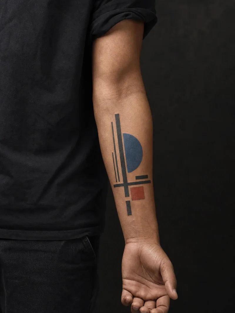 Bauhaus forearm tattoo - Bars, a semicircle and one square create a vertical rhythm.
