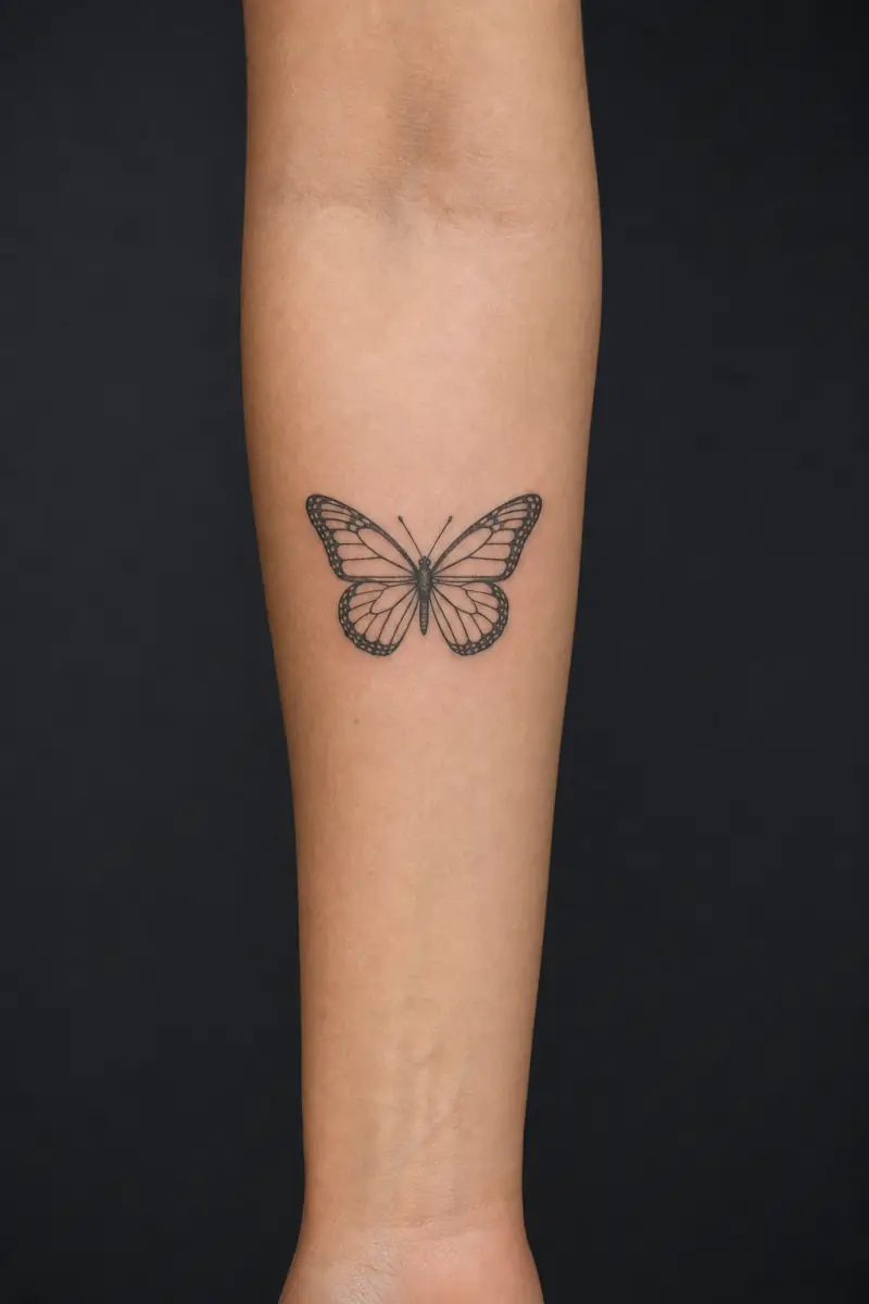 A 5 cm butterfly tattoo on a forearm